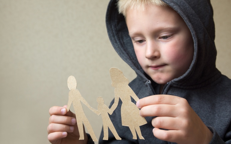 Gutt med familiefigurer av papp